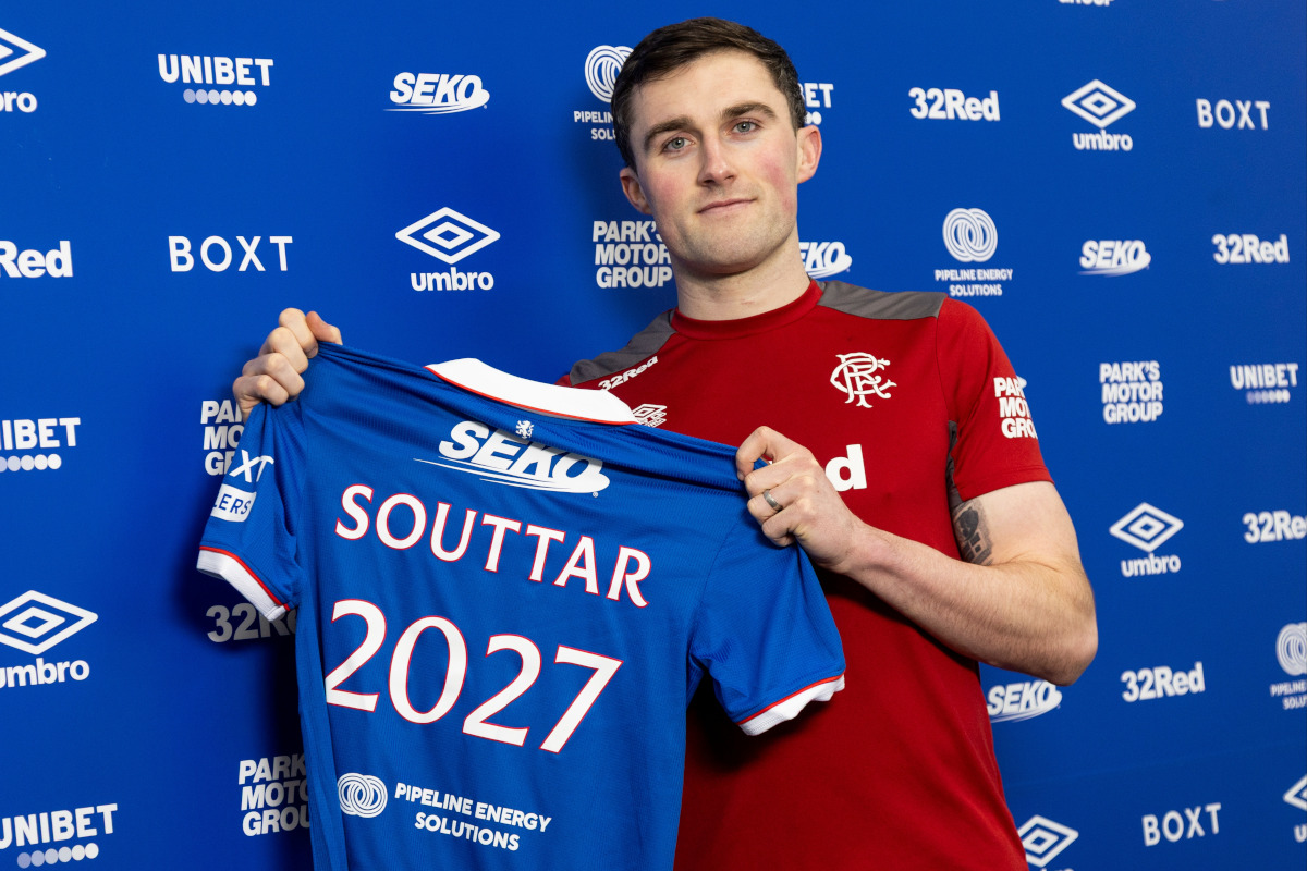 John Souttar has signed a new contract until 2027 and he is holding a Rangers top with 2027 on the back of it